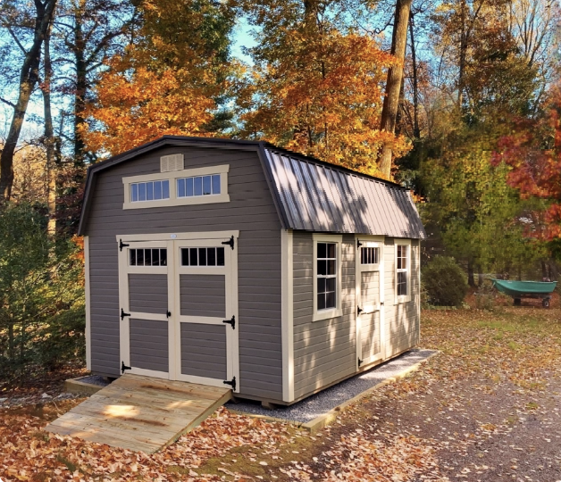 tan shed on a stone foundation in autumn