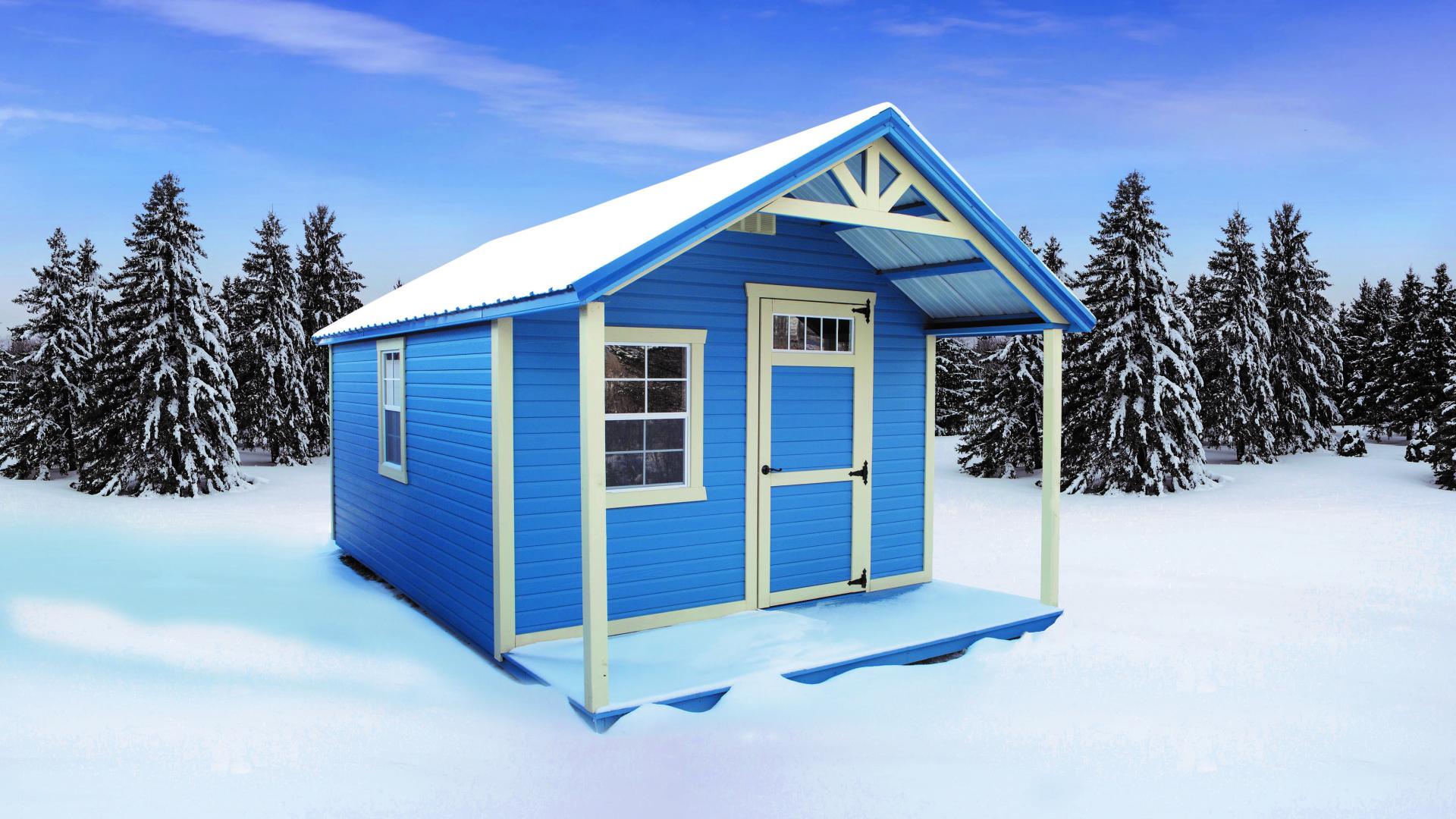 Light blue hunting cabin in a snowy area
