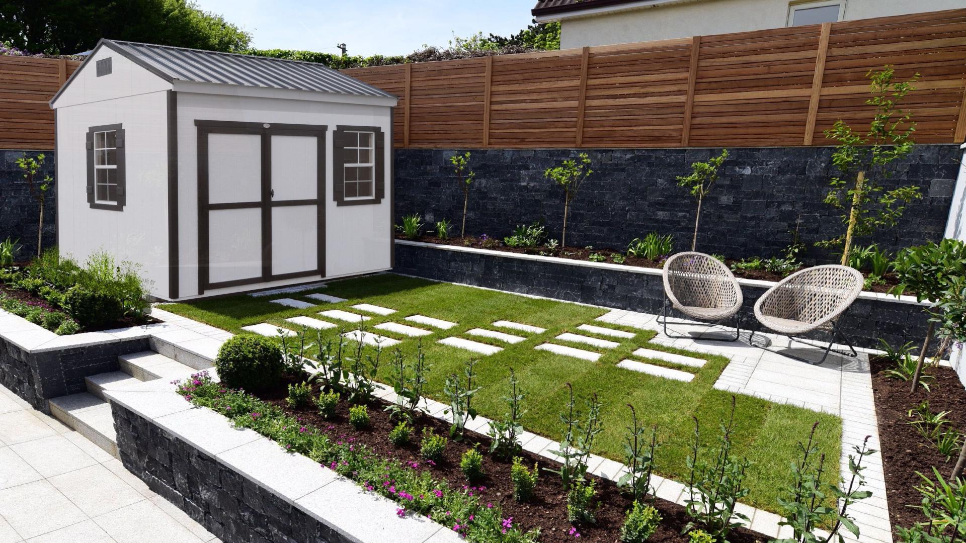 White Compass Big Sky Shed with black trim, windows, double doors, and a gray roof.